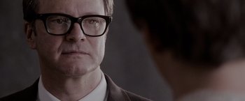 Movie still from “A Single Man” (2009), directed by Tom Ford – A person wearing a suit and glasses; Close Up shot, Over the shoulder angle