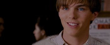 Movie still from “A Single Man” (2009), directed by Tom Ford – A person with a smile on their face; Close Up shot, Over the shoulder angle