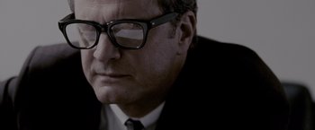 Movie still from “A Single Man” (2009), directed by Tom Ford – A person wearing glasses and a suit; Close Up shot, Low angle