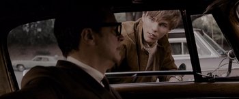 Movie still from “A Single Man” (2009), directed by Tom Ford – A man looking at another man in the back of a car; Close Up shot, Over the shoulder angle