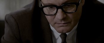 Movie still from “A Single Man” (2009), directed by Tom Ford – A person wearing a suit and glasses; Close Up shot, Over the shoulder angle