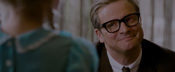Movie still from “A Single Man” (2009), directed by Tom Ford – A person wearing a suit and glasses; Close Up shot, Over the shoulder angle