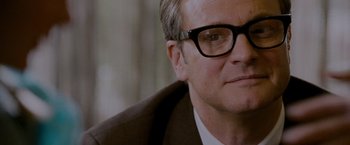 Movie still from “A Single Man” (2009), directed by Tom Ford – A person wearing a suit and glasses; Close Up shot, Over the shoulder angle