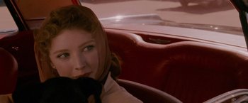 Movie still from “A Single Man” (2009), directed by Tom Ford – A woman sitting in the back seat of a car; Close Up shot, Over the shoulder angle