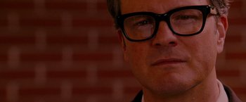 Movie still from “A Single Man” (2009), directed by Tom Ford – A person wearing a suit and glasses; Close Up shot, Low angle