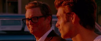 Movie still from “A Single Man” (2009), directed by Tom Ford – A man in a suit and a man in a tie; Close Up shot, Over the shoulder angle