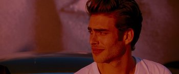 Movie still from “A Single Man” (2009), directed by Tom Ford – A person wearing a white t - shirt; Close Up shot, Over the shoulder angle