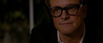 Movie still from “A Single Man” (2009), directed by Tom Ford – A person wearing glasses and a suit; Close Up shot, Over the shoulder angle
