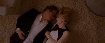 Movie still from “A Single Man” (2009), directed by Tom Ford – A man and a woman laying on the ground; Medium shot, Overhead angle