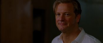 Movie still from “A Single Man” (2009), directed by Tom Ford – A person wearing a white shirt; Close Up shot, Over the shoulder angle