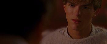Movie still from “A Single Man” (2009), directed by Tom Ford – A person wearing a white sweater; Close Up shot, Over the shoulder angle