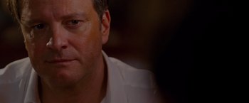 Movie still from “A Single Man” (2009), directed by Tom Ford – A man's face in a white shirt; Close Up shot, Over the shoulder angle