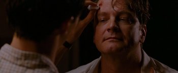 Movie still from “A Single Man” (2009), directed by Tom Ford – A woman is getting makeup done on her face; Close Up shot, Over the shoulder angle