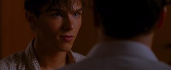 Movie still from “A Single Man” (2009), directed by Tom Ford – A person looking at a camera; Close Up shot, Over the shoulder angle