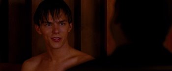 Movie still from “A Single Man” (2009), directed by Tom Ford – A young man with blue eyes is looking at the camera; Close Up shot, Over the shoulder angle