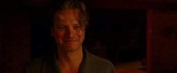 Movie still from “A Single Man” (2009), directed by Tom Ford – A person smiling for the camera; Close Up shot, Over the shoulder angle