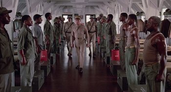 Movie still from “A Soldier's Story” (1984), directed by Norman Jewison – A group of men in uniform walking down a hallway; Wide shot, Low angle