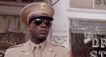 Movie still from “A Soldier's Story” (1984), directed by Norman Jewison – A man in a military uniform wearing sunglasses and a hat; Close Up shot, Low angle