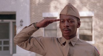 Movie still from “A Soldier's Story” (1984), directed by Norman Jewison – A man saluting with a hat on his head; Close Up shot, Low angle