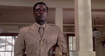Movie still from “A Soldier's Story” (1984), directed by Norman Jewison – A man in a military uniform holding a hat; Close Up shot, Low angle