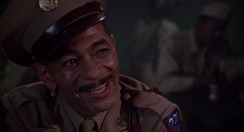 Movie still from “A Soldier's Story” (1984), directed by Norman Jewison – A man in a uniform smiling for the camera; Close Up shot, High angle