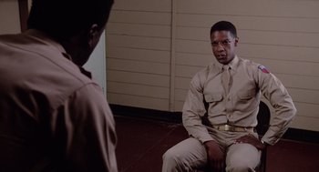 Movie still from “A Soldier's Story” (1984), directed by Norman Jewison – A man in uniform sitting in front of another man in uniform; Medium shot, Over the shoulder angle