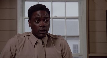 Movie still from “A Soldier's Story” (1984), directed by Norman Jewison – A man wearing a brown shirt and a tie; Close Up shot, Low angle