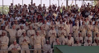 Movie still from “A Soldier's Story” (1984), directed by Norman Jewison – A group of people in the stands clapping; Wide shot, High angle