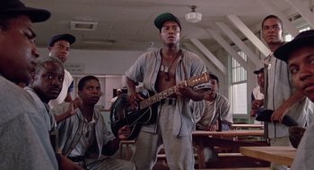 Movie still from “A Soldier's Story” (1984), directed by Norman Jewison – A group of young men sitting in a room; Medium shot, Low angle