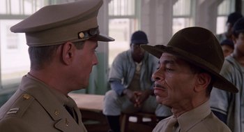 Movie still from “A Soldier's Story” (1984), directed by Norman Jewison – Two men in military uniforms talking to each other; Medium shot, Over the shoulder angle