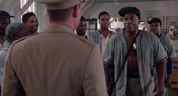 Movie still from “A Soldier's Story” (1984), directed by Norman Jewison – A group of men standing next to each other in a room; Medium shot, Over the shoulder angle