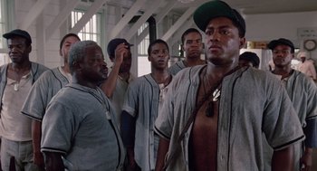 Movie still from “A Soldier's Story” (1984), directed by Norman Jewison – A group of baseball players standing together in a building; Medium shot, Low angle