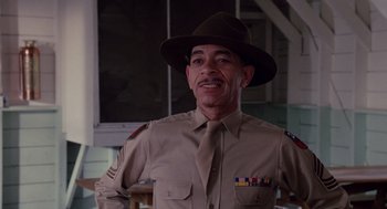 Movie still from “A Soldier's Story” (1984), directed by Norman Jewison – A man in a hat and uniform is smiling for the camera; Medium shot, Low angle
