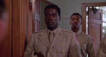 Movie still from “A Soldier's Story” (1984), directed by Norman Jewison – A man in a uniform standing next to another man in a uniform; Close Up shot, Low angle