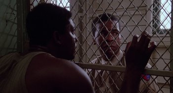 Movie still from “A Soldier's Story” (1984), directed by Norman Jewison – Two men are in a jail cell looking at each other; Close Up shot, Low angle