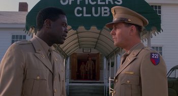 Movie still from “A Soldier's Story” (1984), directed by Norman Jewison – Two men in military uniforms standing in front of a building; Medium shot, Low angle