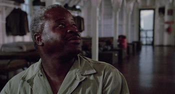 Movie still from “A Soldier's Story” (1984), directed by Norman Jewison – An older black man looking up at the ceiling; Close Up shot, Low angle
