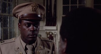 Movie still from “A Soldier's Story” (1984), directed by Norman Jewison – A man in a uniform talking to a woman in a room; Close Up shot, Over the shoulder angle