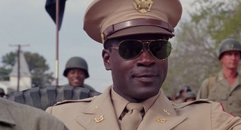 Movie still from “A Soldier's Story” (1984), directed by Norman Jewison – A person wearing a uniform and sunglasses; Close Up shot, Low angle