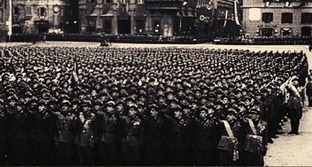 Movie still from “A Special Day” (1977), directed by Ettore Scola – A large group of men in uniform saluting; Extreme Wide shot, High angle
