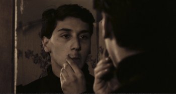 Movie still from “A Special Day” (1977), directed by Ettore Scola – A man looking at his reflection in a mirror; Close Up shot, Over the shoulder angle