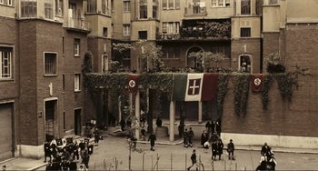 Movie still from “A Special Day” (1977), directed by Ettore Scola – A group of people standing in front of a building; Extreme Wide shot, High angle