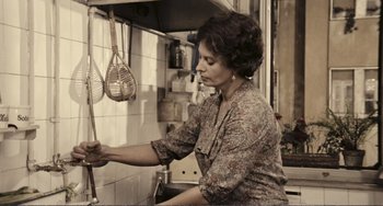 Movie still from “A Special Day” (1977), directed by Ettore Scola – A woman in a kitchen holding a spatula; Medium shot, Low angle