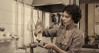 Movie still from “A Special Day” (1977), directed by Ettore Scola – A woman in a kitchen holding a knife; Medium shot, Low angle