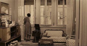 Movie still from “A Special Day” (1977), directed by Ettore Scola – An older woman looking out of a window; Wide shot, High angle