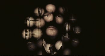 Movie still from “A Special Day” (1977), directed by Ettore Scola – A black and white photo of a man in a suit and tie; Close Up shot, Overhead angle