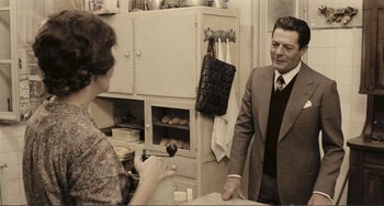 Movie still from “A Special Day” (1977), directed by Ettore Scola – An older man in a suit and tie talking to an older woman in a dress; Medium shot, Over the shoulder angle