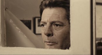 Movie still from “A Special Day” (1977), directed by Ettore Scola – A black and white photo of a man looking out of a window; Close Up shot, Low angle