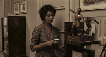 Movie still from “A Special Day” (1977), directed by Ettore Scola – A woman holding a cup in her hands; Medium shot, Low angle