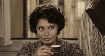 Movie still from “A Special Day” (1977), directed by Ettore Scola – A woman is holding a cup of coffee; Close Up shot, High angle